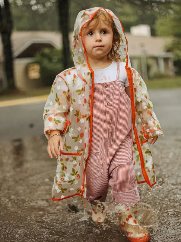 Little girl in a floral raincoat in a puddle, outdoor photography by Photoholic, Rockland County NY