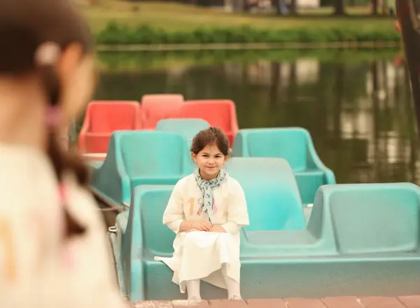 Toddler sitting in a teal paddle boat, outdoor photography by Photoholic, Rockland County NY