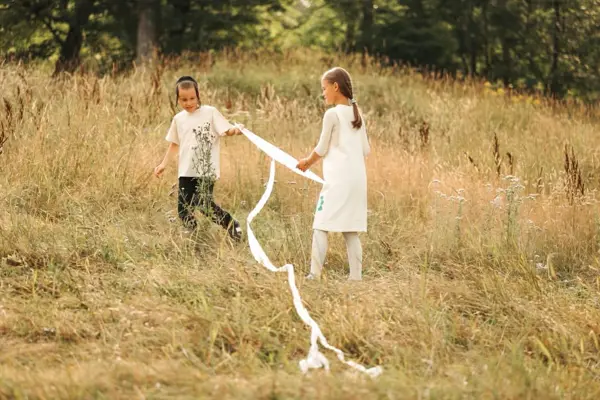 Brother and sister running with ribbons in a meadow, outdoor photography by Photoholic, Rockland County NY